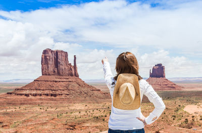 Rear view of woman looking at rock formation