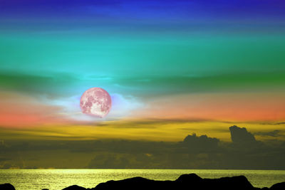 Scenic view of dramatic landscape against sky during sunset