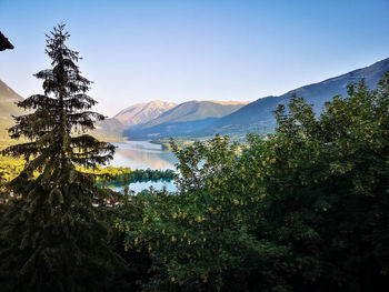 Scenic view of lake and mountains against sky