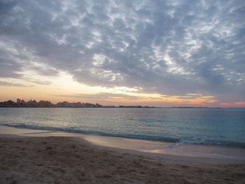 Scenic view of beach against sky during sunset