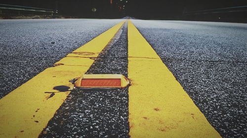 Close-up of yellow arrow symbol on road