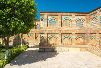 Entrance of historic building against blue sky