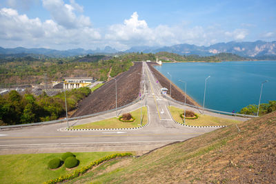 Scenic view of road by mountain against sky