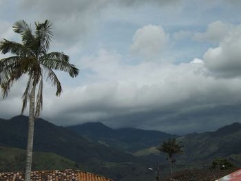 Scenic view of mountains against cloudy sky