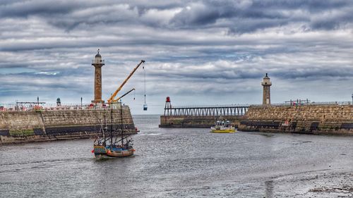 View of ship in sea against cloudy sky