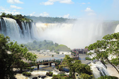 Scenic view of waterfall against sky