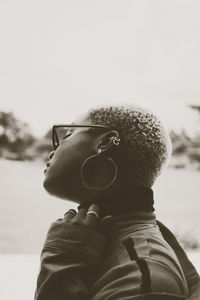 Portrait of boy looking at camera against sky