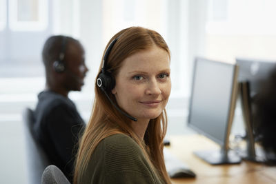 Portrait of smiling female call center employee
