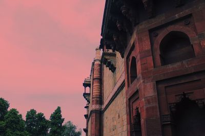 Low angle view of building against sky during sunset