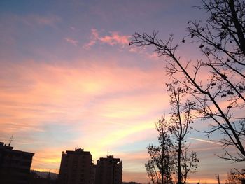 Low angle view of building against sky at sunset