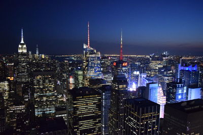 Illuminated buildings in city at night