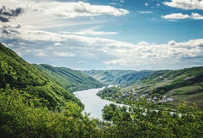 Scenic view of river and mountains against sky