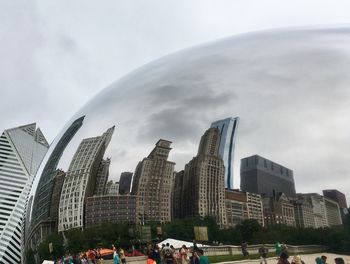 Panoramic view of buildings in city against sky