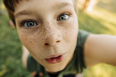 Close-up portrait of boy with freckles at summer camp
