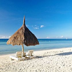 Scenic view of beach against blue sky