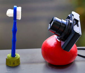 Close-up of camera and tooth brush