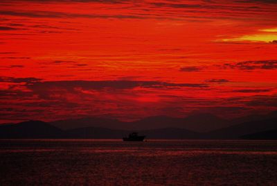 Scenic view of sea against orange sky