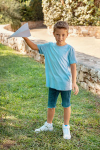 Full length of boy standing on field