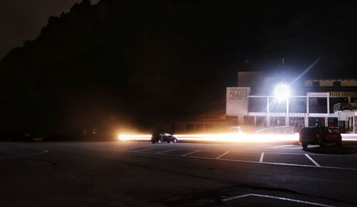 Cars on city street at night