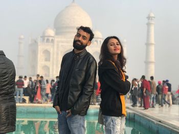 Portrait of friends standing at historic temple