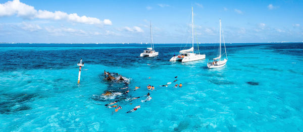 Boats in sea against sky