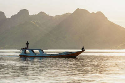 Man on boat in sea against sky