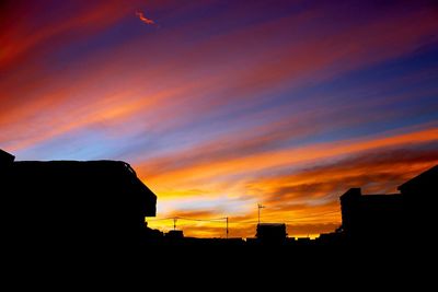 Low angle view of silhouette buildings against sky during sunset