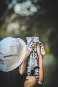 Midsection of woman holding cat