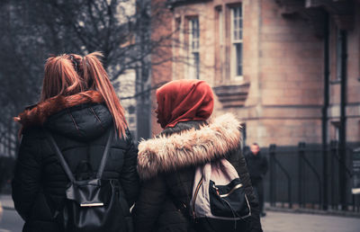 Rear view of women standing in winter