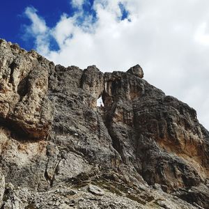 Low angle view of rocky mountain against sky