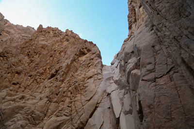 Low angle view of rock formations against sky