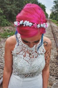 Midsection of woman standing by flowering plant