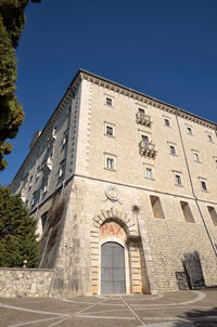 Low angle view of building against clear blue sky