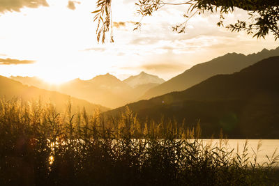 Scenic view of mountains against sky at sunset