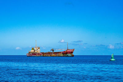 Scenic view of sea against blue sky