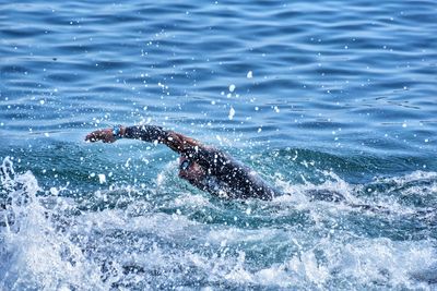 Side view of man swimming in sea