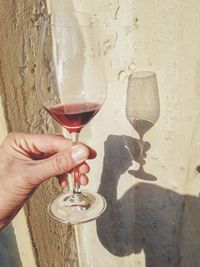 Close-up of hand holding wine glass