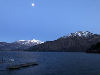 Scenic view of snowcapped mountains against blue sky