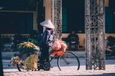 Man with bicycle in front of building