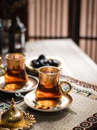 A glass of turkish tea on the table. conceptual stilllife photograhy with ramadan vibes concept