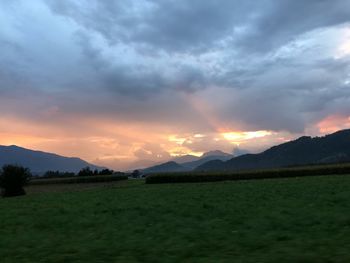 Scenic view of field against sky during sunset