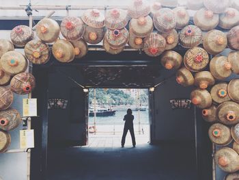 Rear view of man standing at store