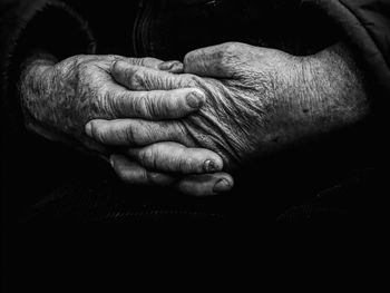 Close-up of man hand over black background