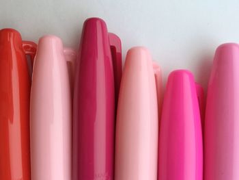 Close-up of pink and red pens on desk