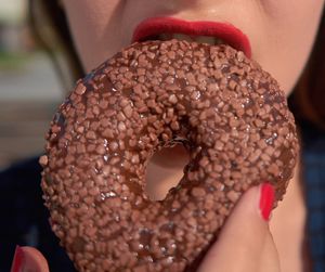 Close-up of woman eating donut