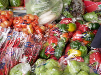 Colorful fresh organic vegetables for sale at a local market in plastic bags
