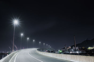 Light trails on road in city at night