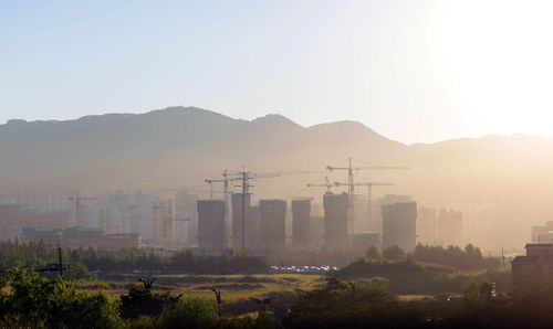 Buildings in city against clear sky