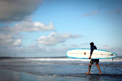 Man on beach against sky