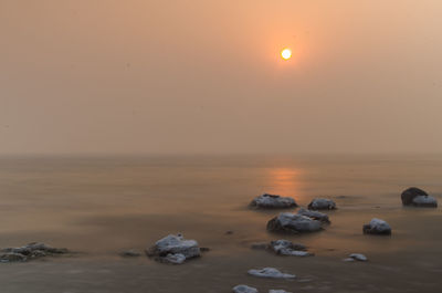 View of beach against sky during sunset
